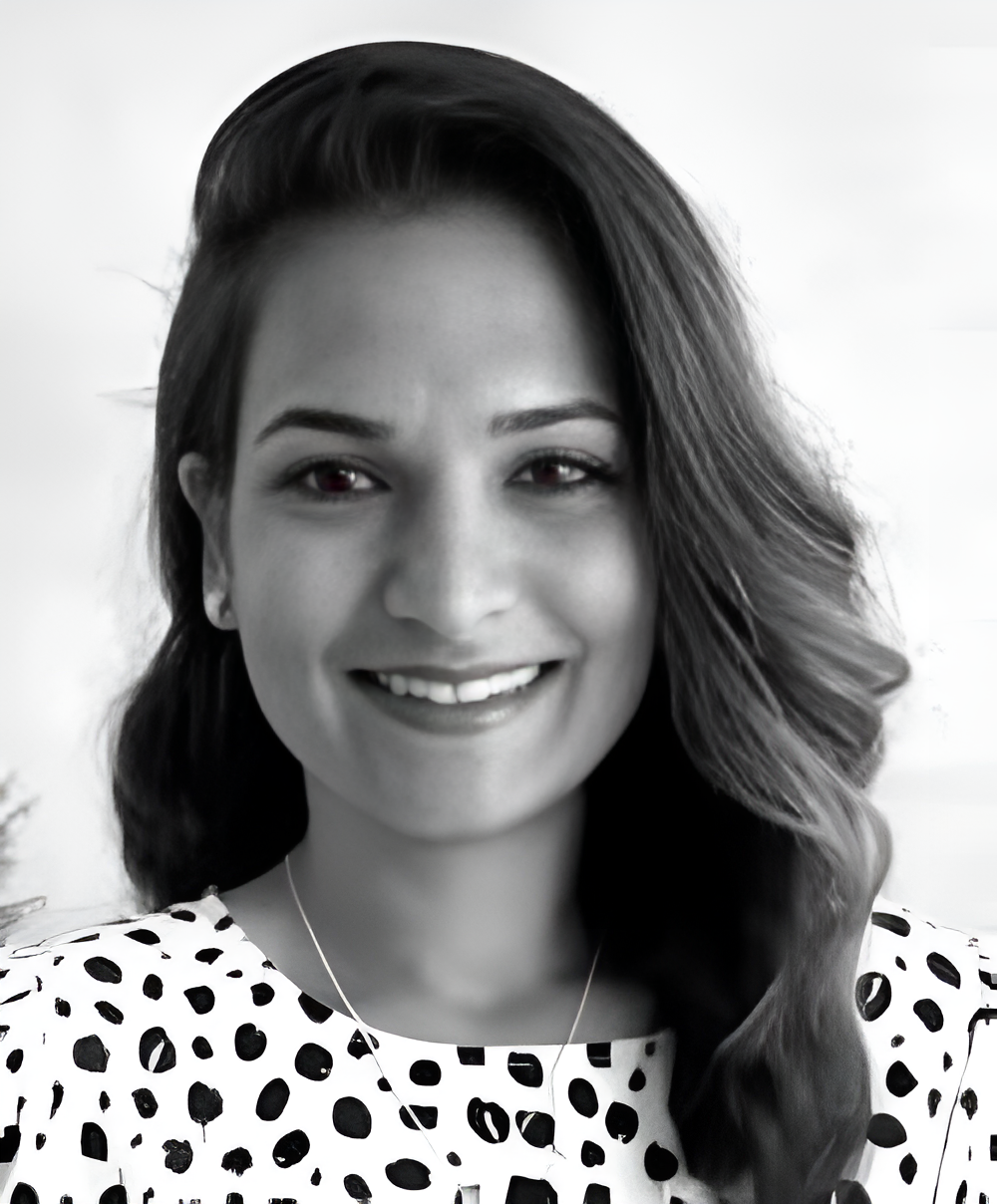 Photo of Dr. Raisa Bhikoo, a pulmonologist, smiling in her office.