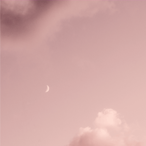 A serene pink sky filled with fluffy white clouds.